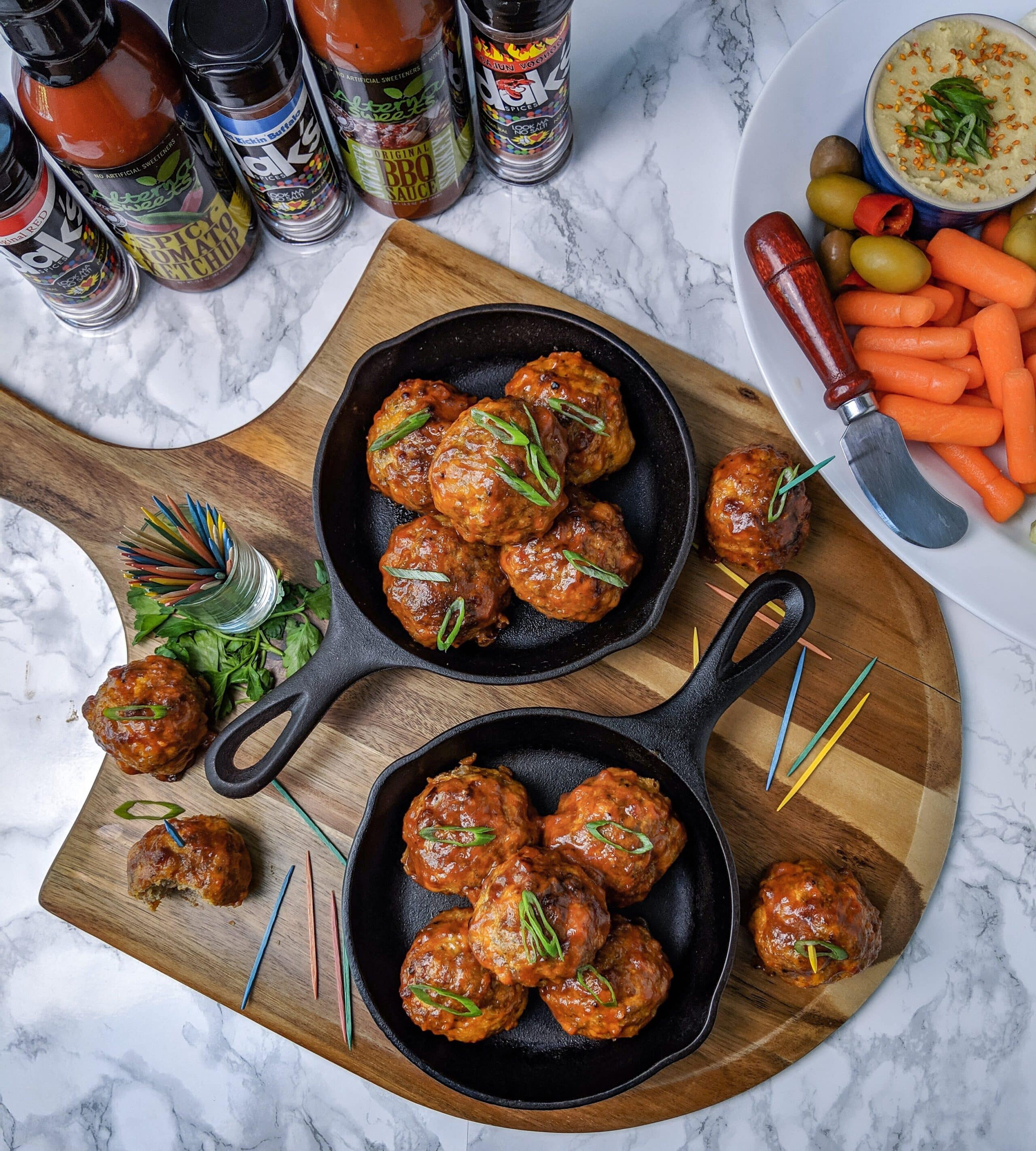 overhead view of cajun bbq sausage bites served in cast iron skillets
