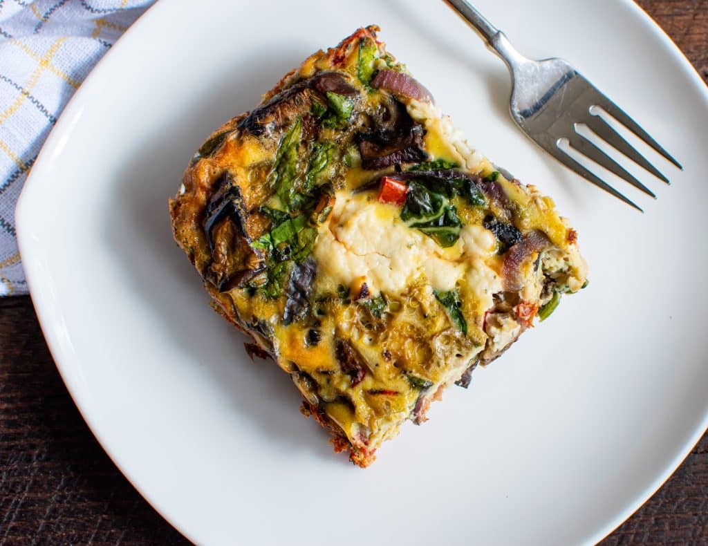 Sliced Bacon and Boursin egg casserole sitting on a plate