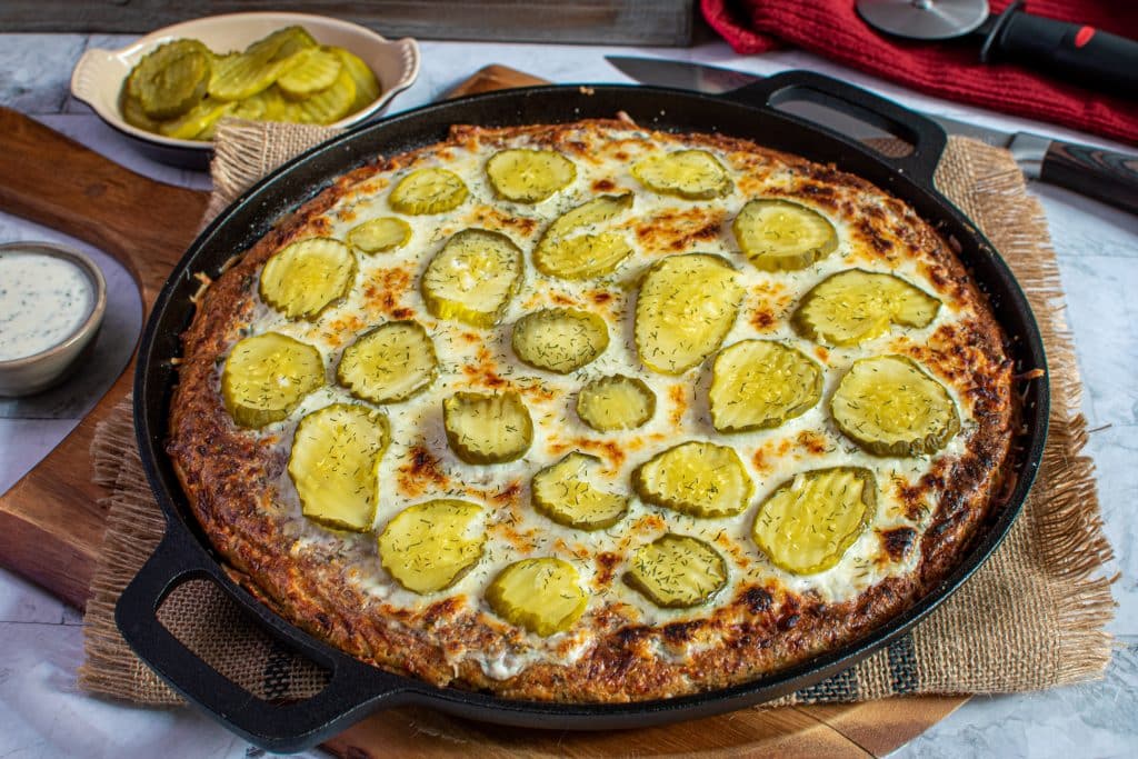 low carb dill pickle pizza served on a cast iron pan