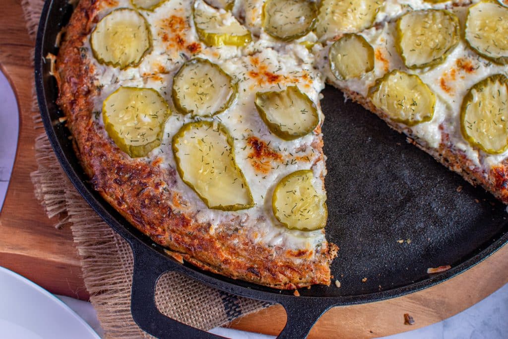 low carb dill pickle pizza served on a cast iron pan