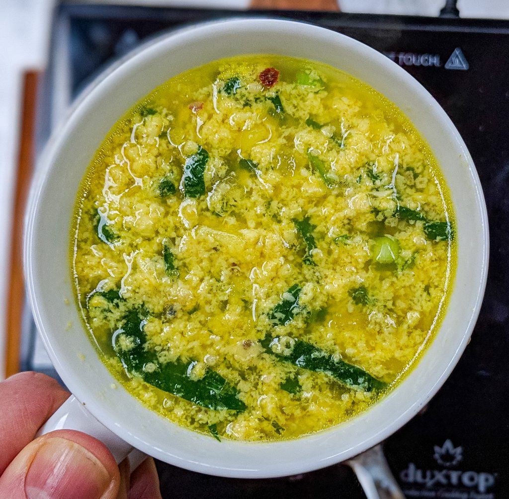 Overhead view of Stracciatella soup in a mug