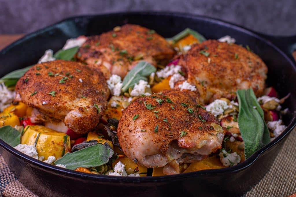 boneless chicken thighs in a cast iron pan with Boursin cheese and pepitas