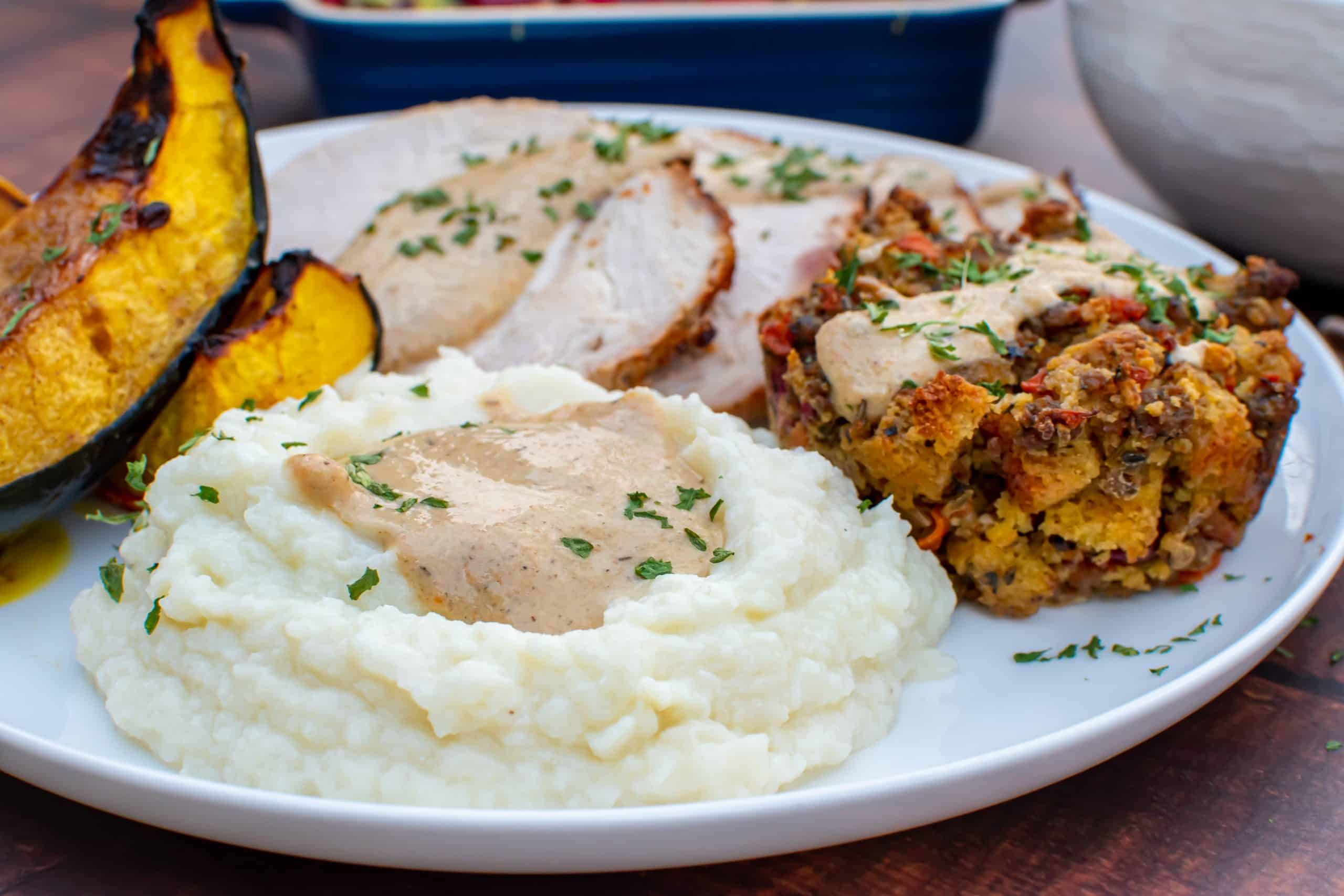 Ricotta cauliflower mash on a thanksgiving plate with mushroom gravy