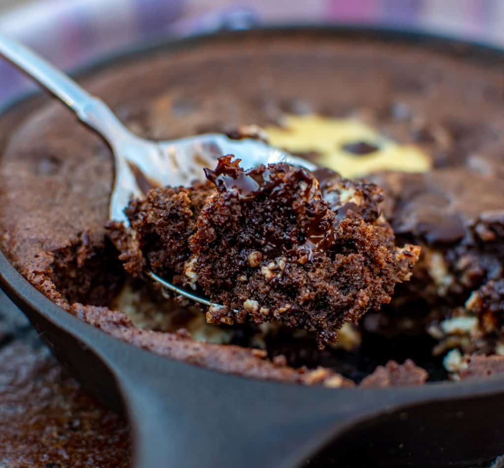 spoonful of Keto brownie in a cast iron skillet