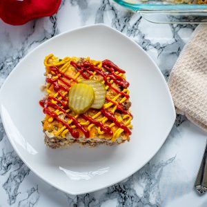 keto cheeseburger brunch cassarole topped with ketchup and mustard