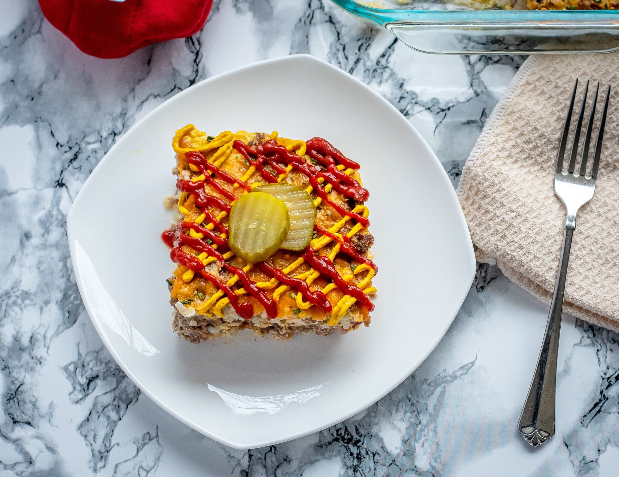 keto cheeseburger brunch cassarole topped with ketchup and mustard