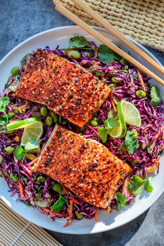Asian red cabbage slaw with creamy cilantro lime dressing topped with salmon