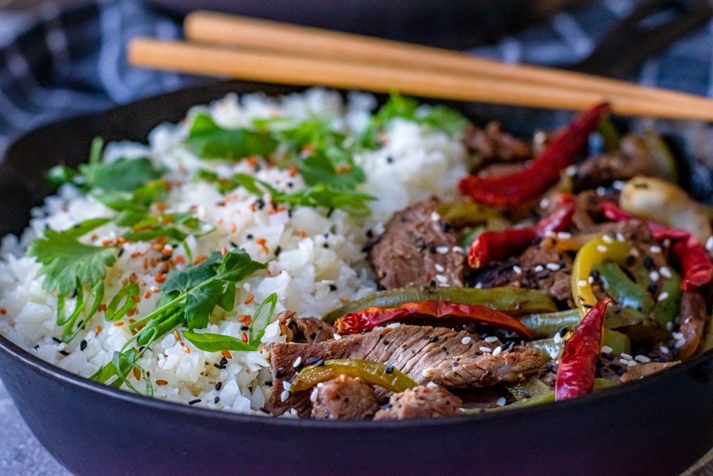 Low carb pepper steak in cast iron skillet with chop sticks