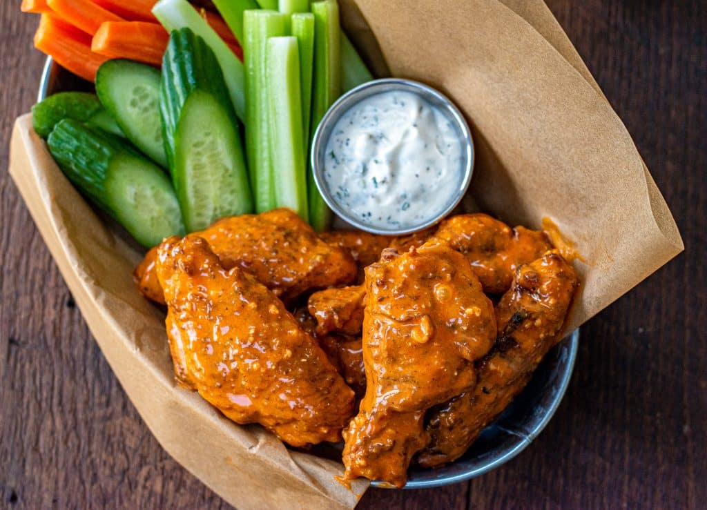 Smoked wings tossed in Chesapeake garlic parm sauce served with carrots, celery, cucumber and ranch dressing