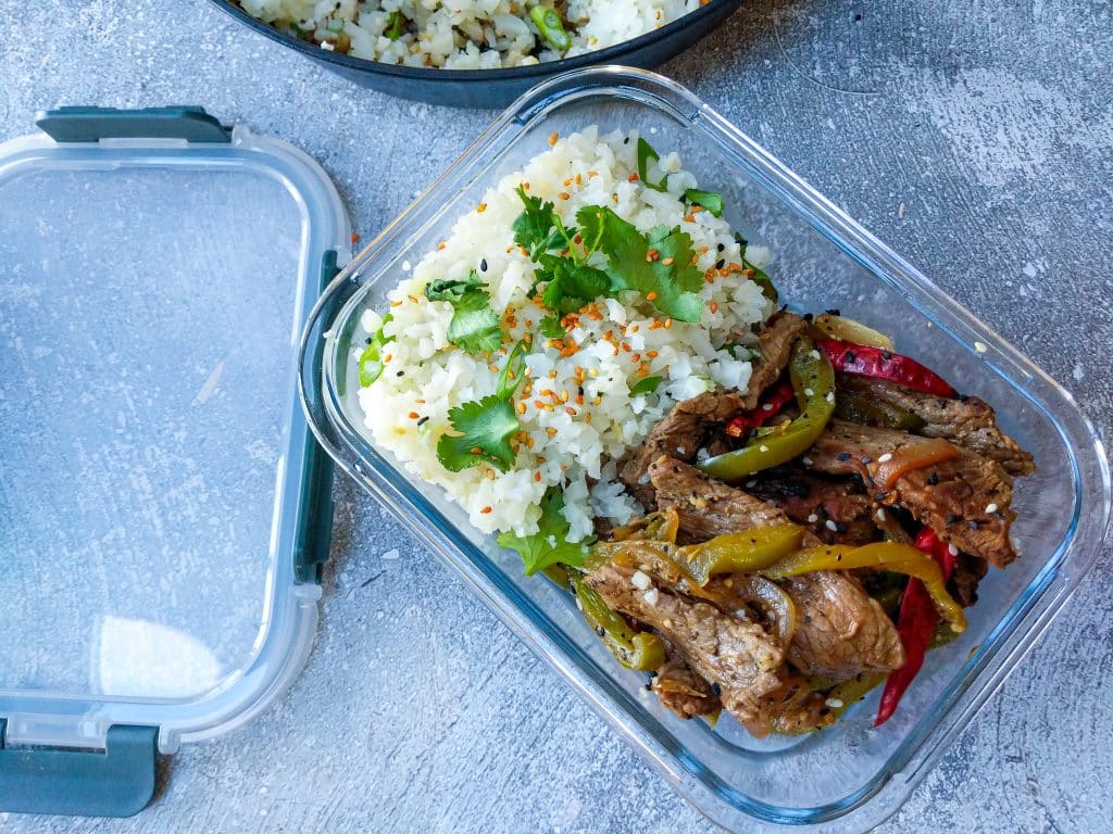 keto peppersteak portioned into glass meal prep container