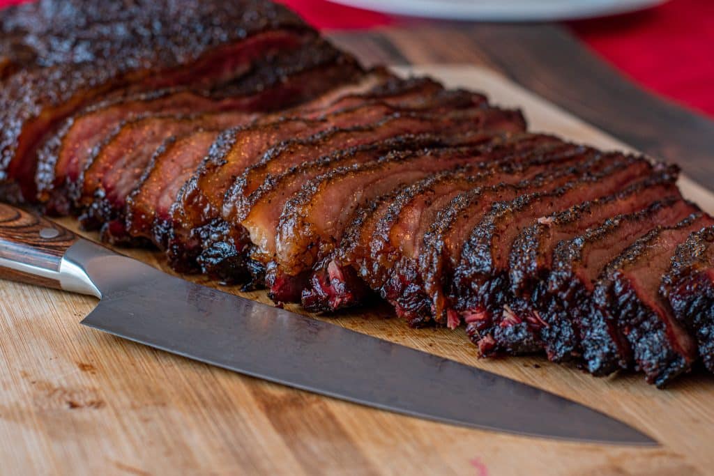 sliced texas brisket cooked on pellet smoker