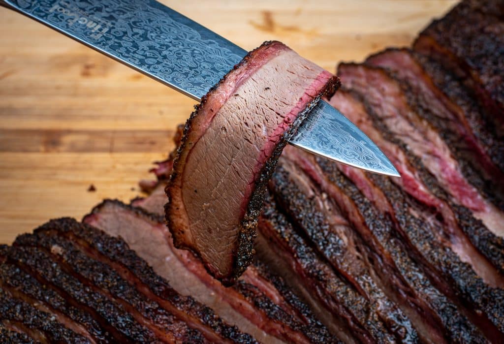 slice of texas brisket very tender with beautiful smoke ring