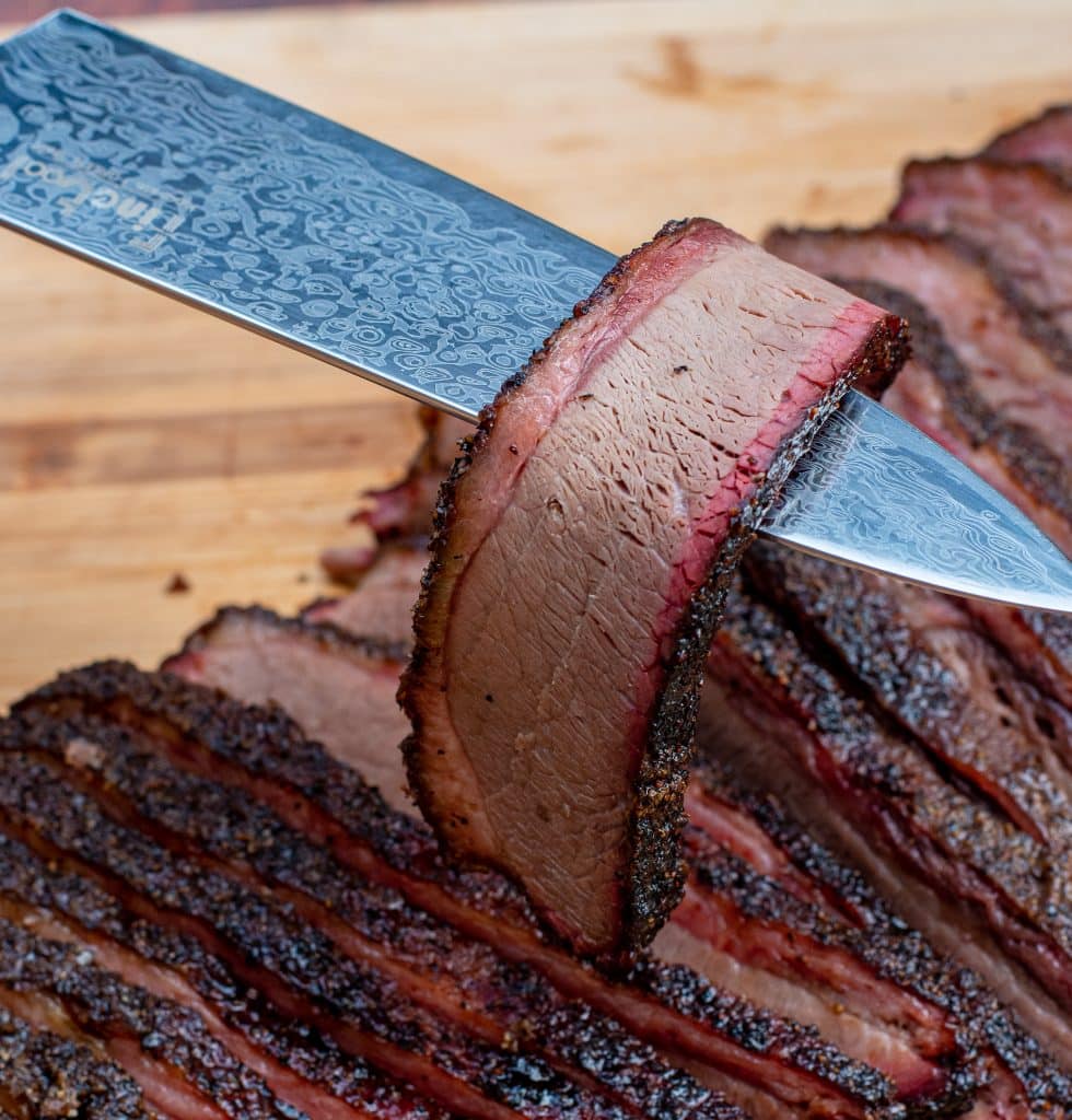 slice of texas brisket very tender with beautiful smoke ring