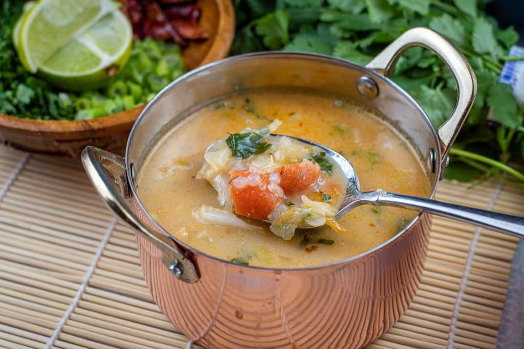 copper pot full of low carb tom yum soup with miracle rice