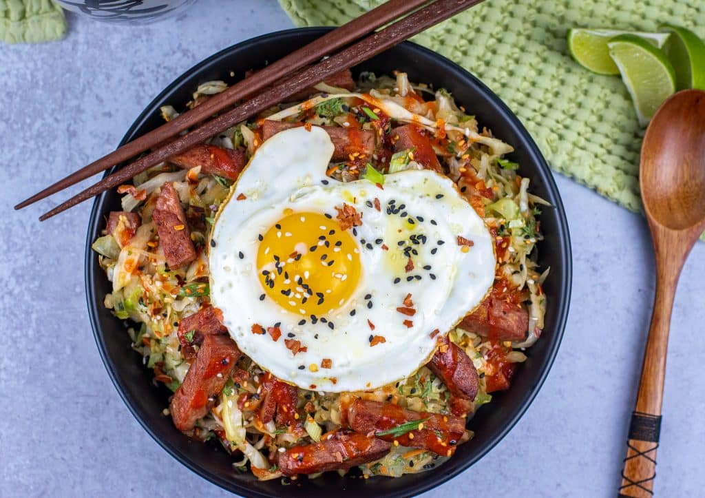 Keto spam egg roll bowl topped with a fried egg
