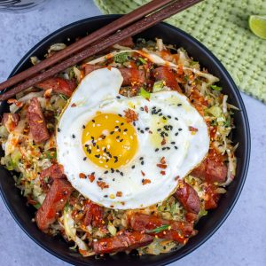 Keto spam egg roll bowl topped with a fried egg