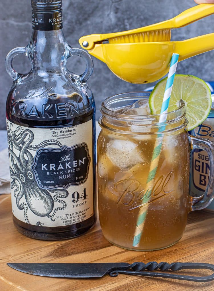 squeezing fresh lime juice into a keto dark and stormy