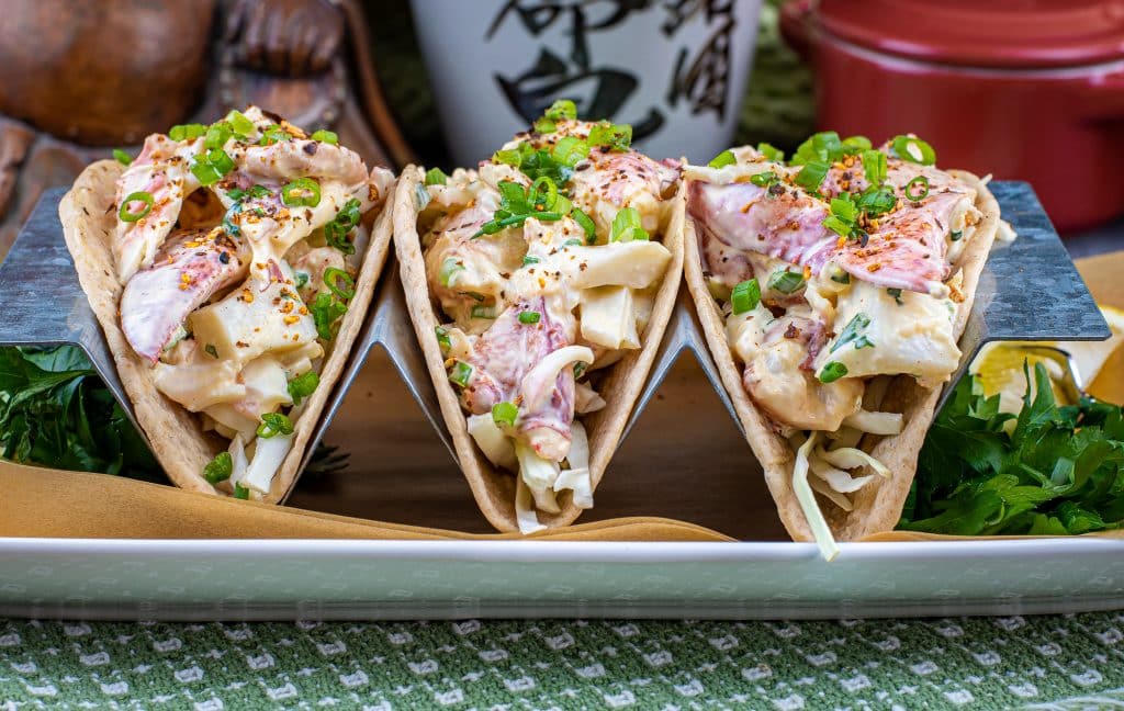 sriracha lobster roll tacos topped with scallions and togarashi