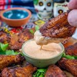 chili rubbed wings dipped in chipotle ranch dressing