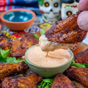 chili rubbed wings dipped in chipotle ranch dressing