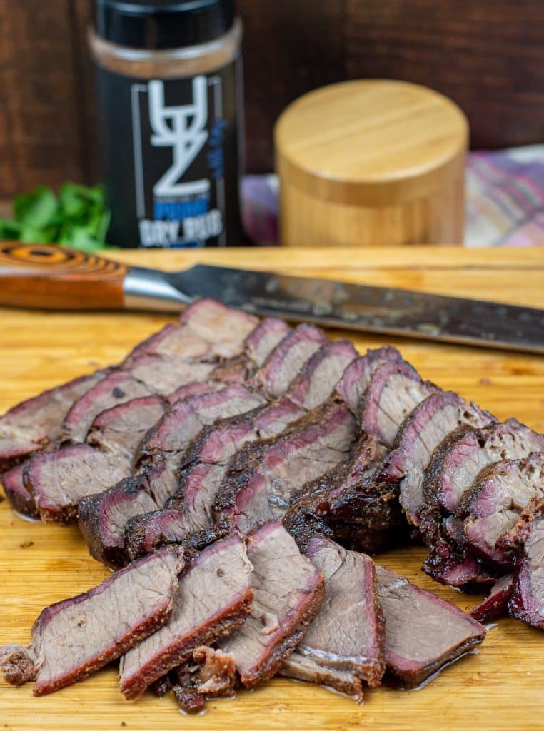 sliced smoked chuck roast on a cutting board