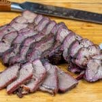 sliced smoked chuck roast on a cutting board