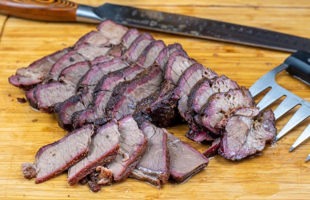 sliced smoked chuck roast on a cutting board