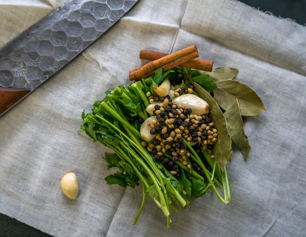 sachet bag of cinnamon, coriander, peppercorns, cilantro stems and garlic to make birria tacos