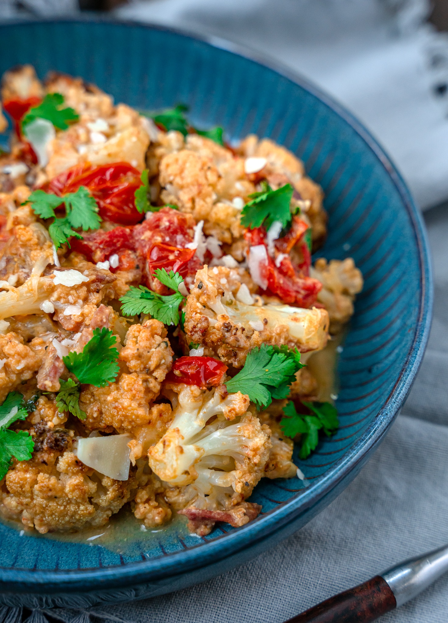 baked feta with tomatoes cauliflower and prosciutto