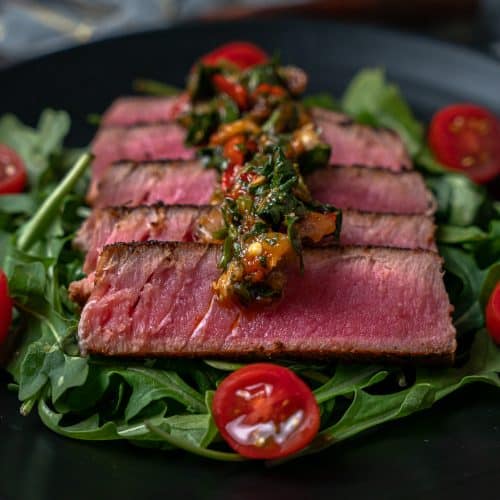 sliced blackened tuna fanned out on a plate