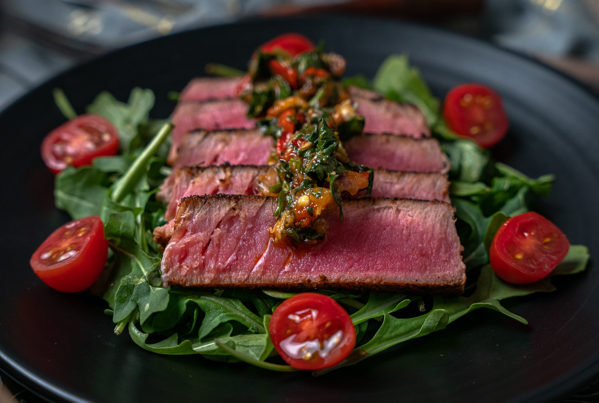 sliced blackened tuna fanned out on a plate
