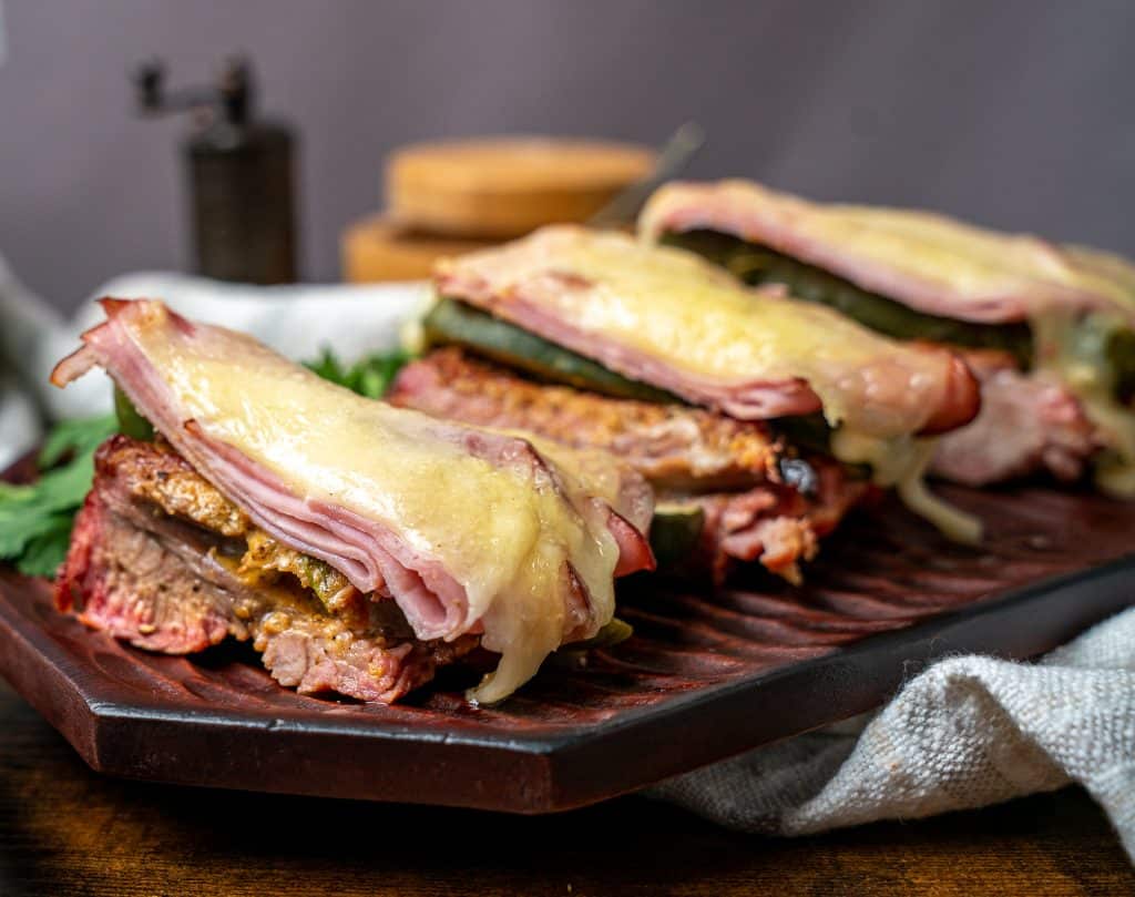 mojo marinated baby back ribs topped with pickles, Swiss and ham