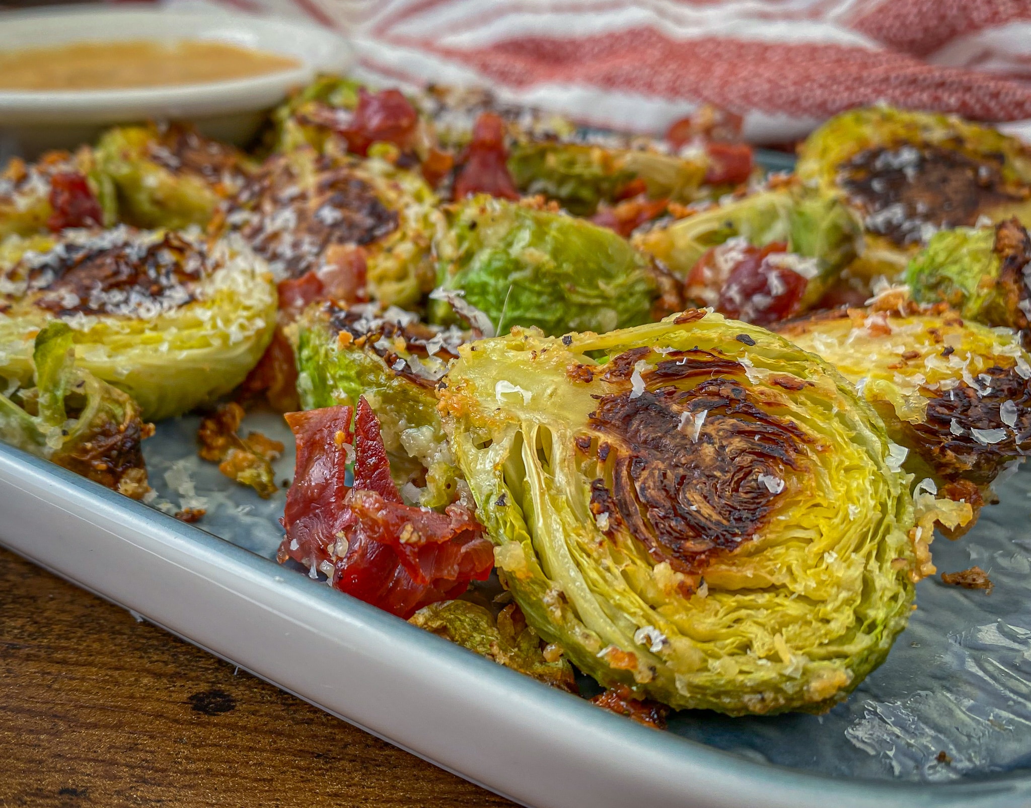 keto roasted brussel sprouts topped with Parmesan Cheese and crispy prosciutto
