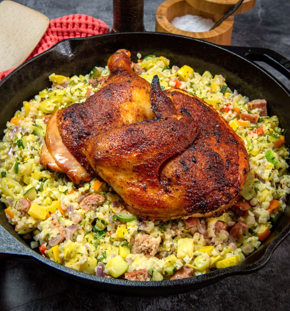 Cauliflower risotto topped with a smoked half chicken