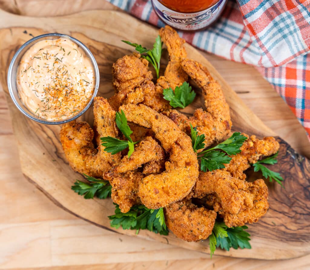 overhead fried shrimp on board with dipping sauce