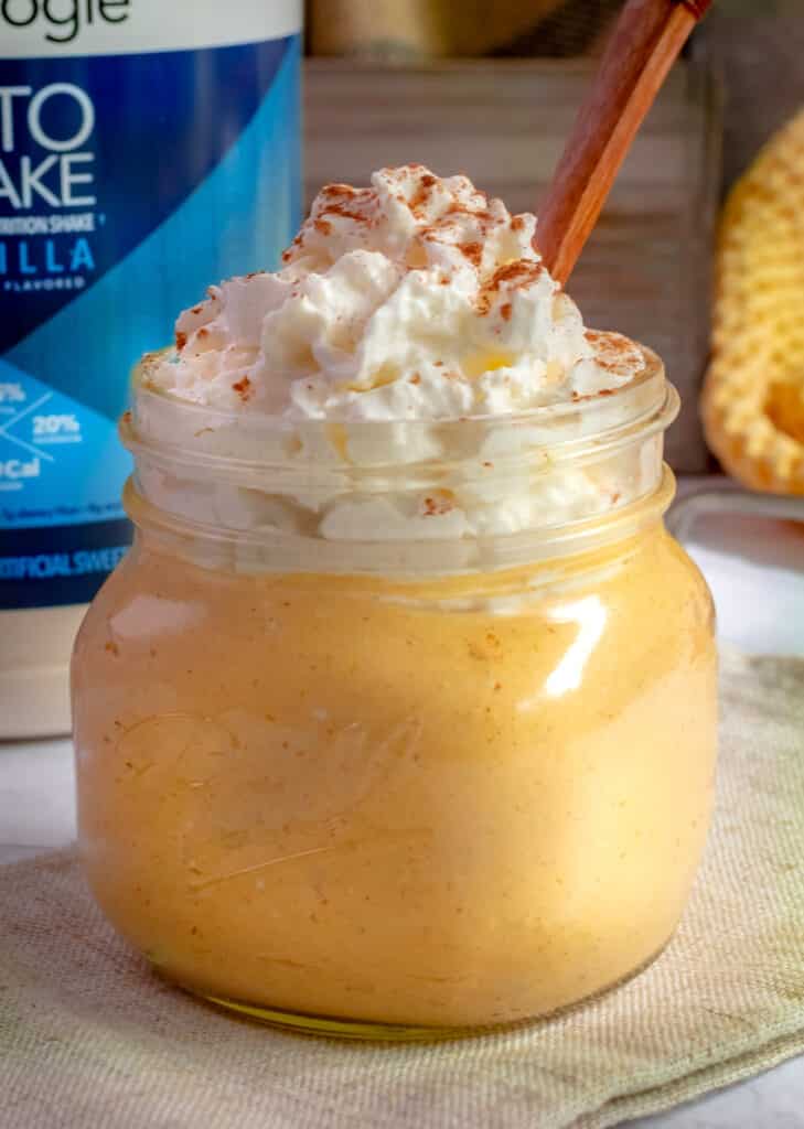 protein cheesecake in a mason jar topped with whipped cream