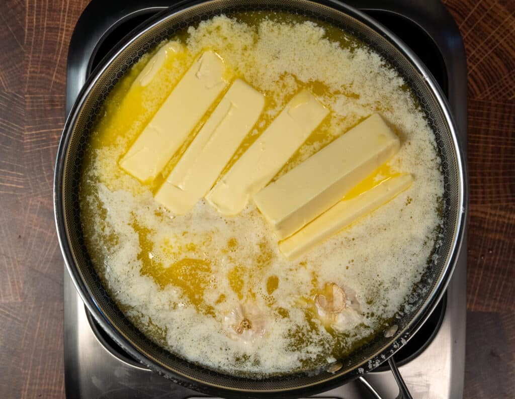 Many sticks of butter melting in a pan
